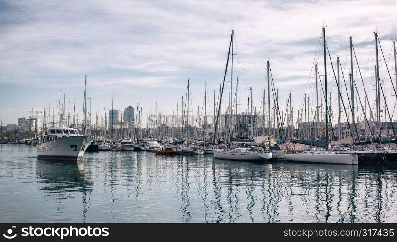 Yachts in the port Barcelona, Sailboat harbor, many beautiful moored sail yachts in the sea port, modern water transport. Spain. Yachts in the port of Barcelona
