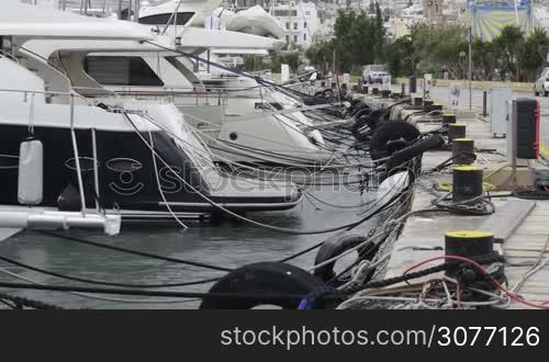 Yachts moored at Manoel Island Marina in Malta. Sail boats in a row on docks at seaside harbor.