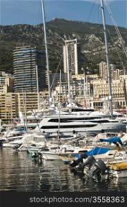 Yachts moored in Monaco. Buildings from Monaco in the background.