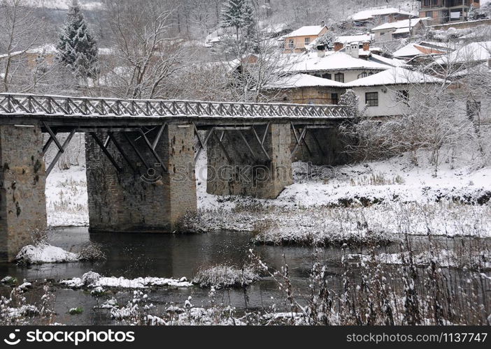 Yantra river, Vladishki bridge and residential area in the town of Veliko Tarnovo in Bulgaria in December