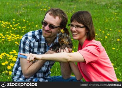 yarn man and girl with york terrier on wild meadow with dandelion