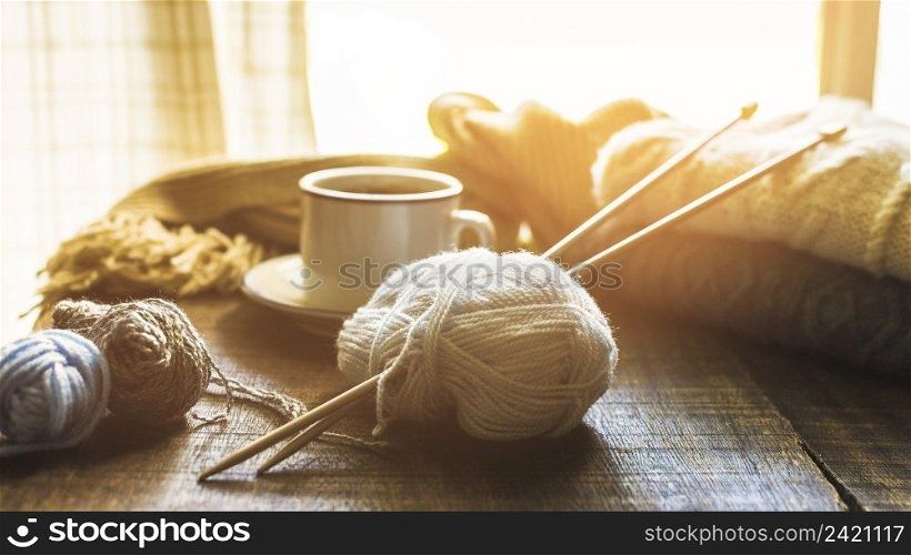 yarn needles near hot beverage