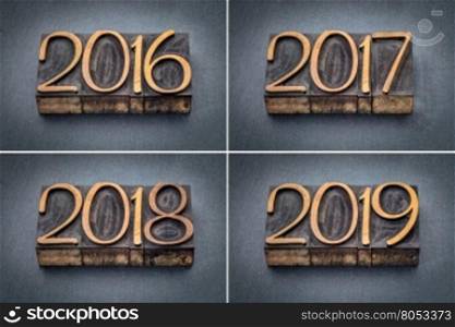 year 2016, 2017, 2018 and 2019 set - text in letterpress wood type against gray slate stone