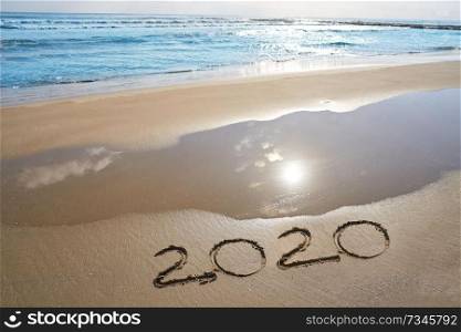 year 2020 numbers spell written on beach sand shore