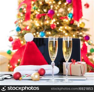 Yearend party time at the workplace with Christmas decorations and drinks on desktop