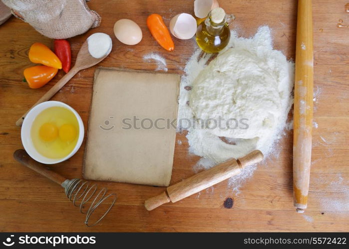 yeast dough, old sheet and flour on wooden background