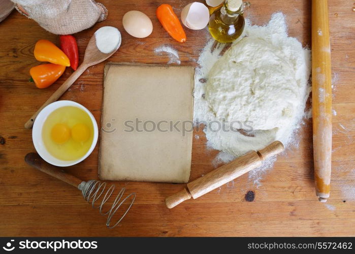 yeast dough, old sheet and flour on wooden background