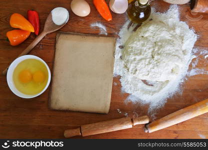 yeast dough, old sheet and flour on wooden background