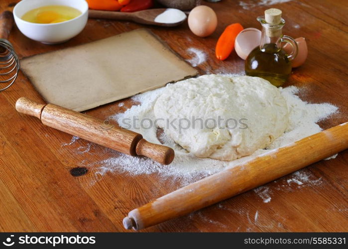 yeast dough, old sheet and flour on wooden background