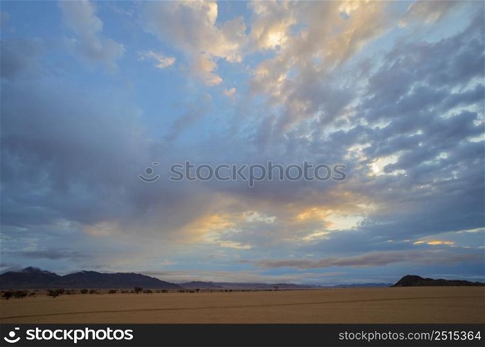 Yellow and blue clouds at sunset in the Namib Desert Namibia