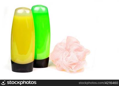 yellow and green colored shower gel bottles and sponge isolated on white