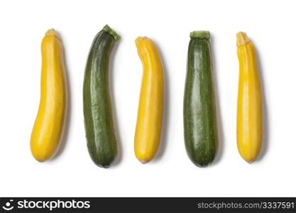 Yellow and green courgettes on white background