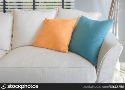 Yellow and green pillow on white sofa set