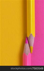 yellow and pink crayons on the same paper background