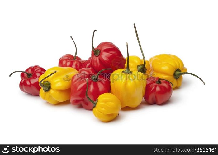 Yellow and red Scotch bonnet chili peppers on white background