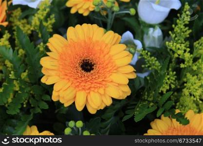 yellow and white flowers in a mixed arrangement