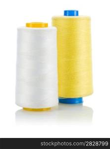 yellow and white thread on spools isolated