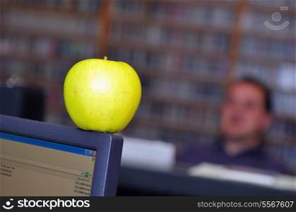yellow apple fruit at working desk at radio station