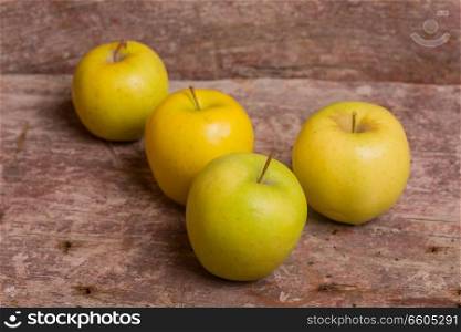 yellow apples on a old wooden background