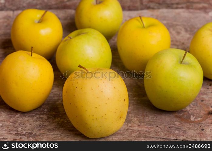 yellow apples on a old wooden background. yellow apples