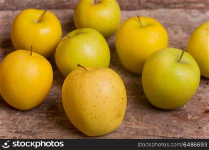 yellow apples on a old wooden background. yellow apples