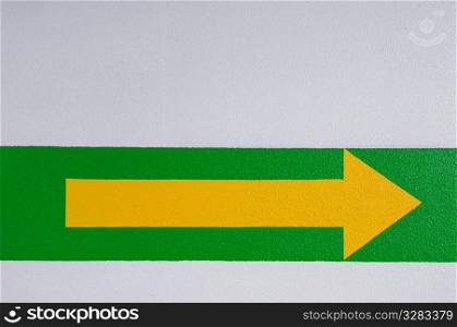 Yellow arrow on green stripe.