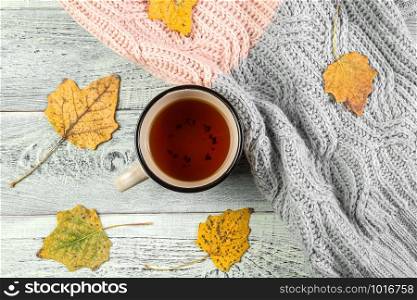 yellow autumn leaves, a Cup of tea on an old wooden background with empty space for text. the view from the top. flat lay