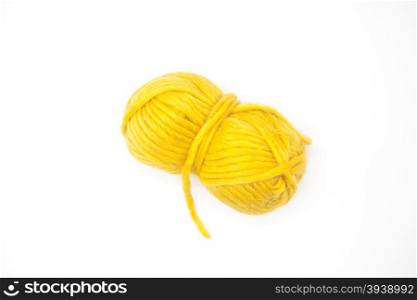 Yellow ball of wool yarn for knitting close up on a white background.. Yellow ball of wool yarn for knitting close up on a white background