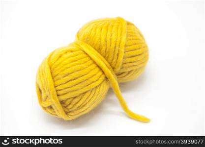 Yellow ball of wool yarn for knitting close up on a white background.. Yellow ball of wool yarn for knitting close up on a white background