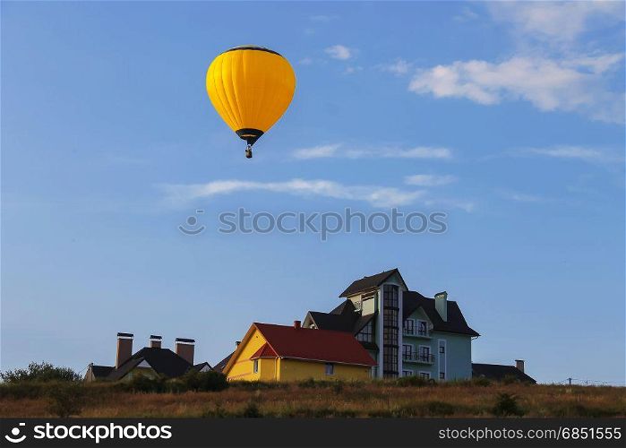 Yellow balloon in blue sky in Schodnica, Ukraine