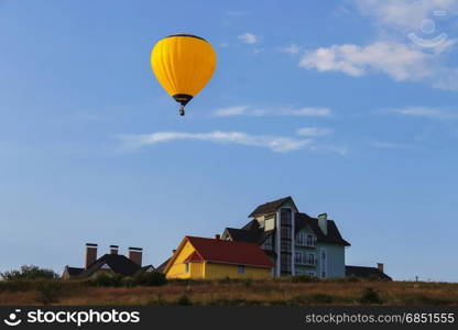 Yellow balloon in blue sky in Schodnica, Ukraine