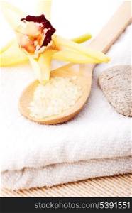 yellow bathing salt in the wooden spoon, spa concept