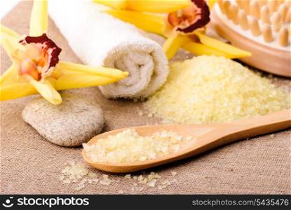 yellow bathing salt in the wooden spoon, spa concept