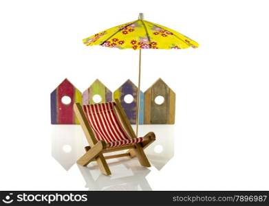 yellow beach umbrella with chair and wooden beach houses