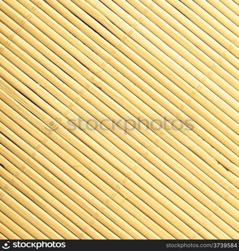 Yellow beige bamboo mat surface pattern diagonal background texture. Square format