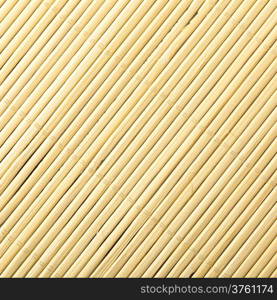 Yellow beige bamboo mat surface pattern diagonal background texture. Square format