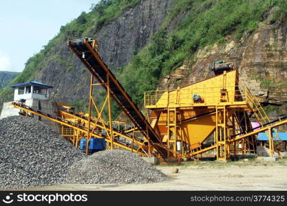 Yellow big gravel conveyor near mount