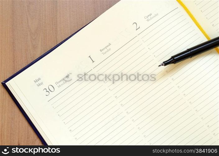 Yellow blank notepad on office wooden table
