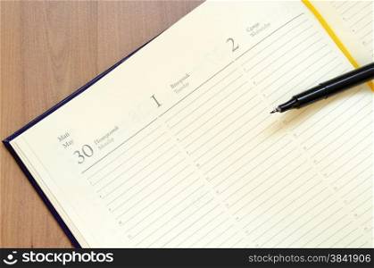 Yellow blank notepad on office wooden table