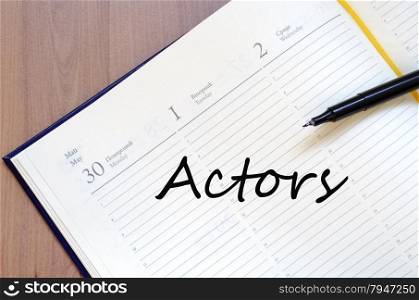 Yellow blank notepad on office wooden table Actors concept