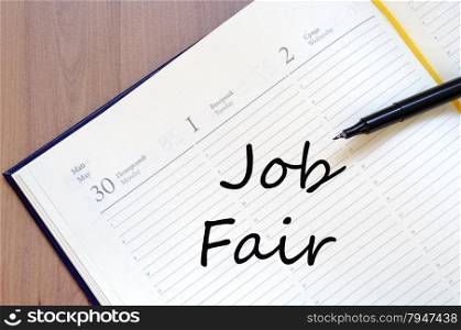 Yellow blank notepad on office wooden table Job Fair concept
