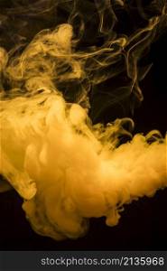yellow bright smoke clouds spread out wide against dark black background