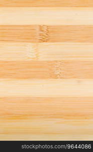Yellow, brown striped wooden cutting board  on white wooden background