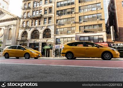 yellow cars near city buildings