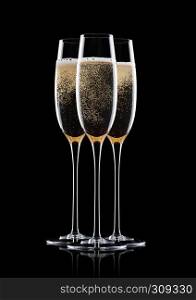 Yellow champagne glasses with bubbles isolated on black background