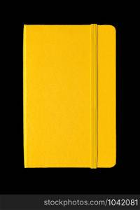 Yellow closed notebook mockup isolated on black. Yellow closed notebook isolated on black