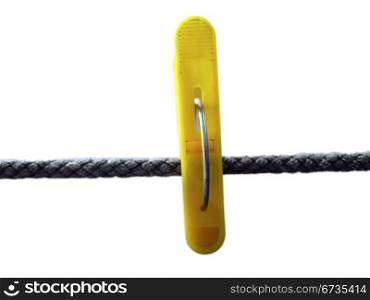 Yellow clothes peg and string on the white background isolated