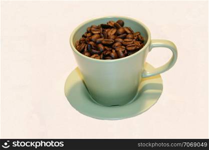 yellow coffee cup filled with coffee beans