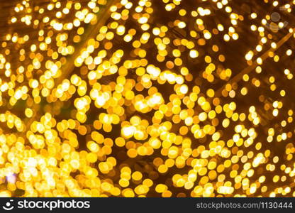 Yellow Colorful light Abstract circular bokeh of Christmas tree background Decoration During Christmas and New Year.