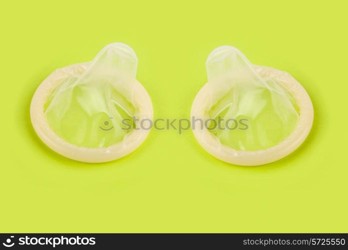 yellow condoms on green background